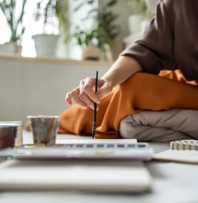 Person painting, showcasing art therapy as a healing method for trauma.