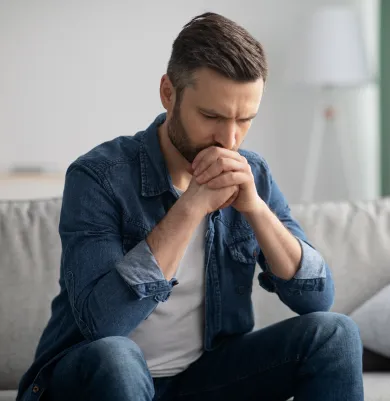 Man deep in thought, representing contemplation and mental health challenges.